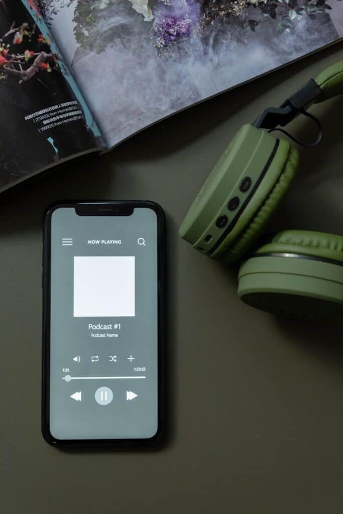 pexels-photo-6686455 Modern smartphone and green headphones next to a magazine, showcasing technology and lifestyle.
